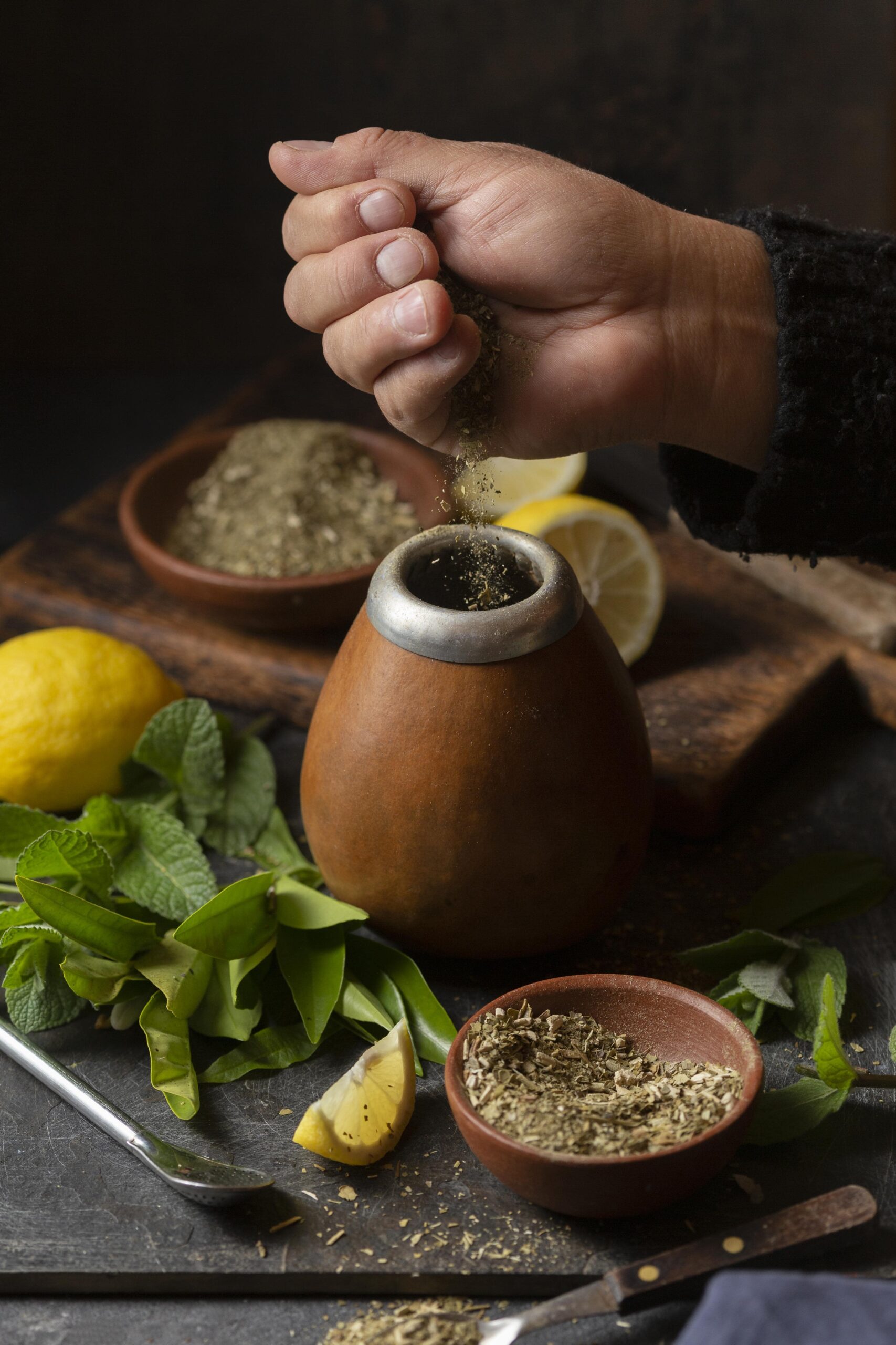 high-angle-person-putting-herbs-infuser-min